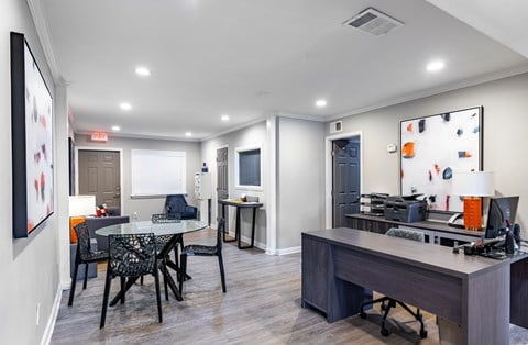 a living room with a dining area and a kitchen with a table and chairs